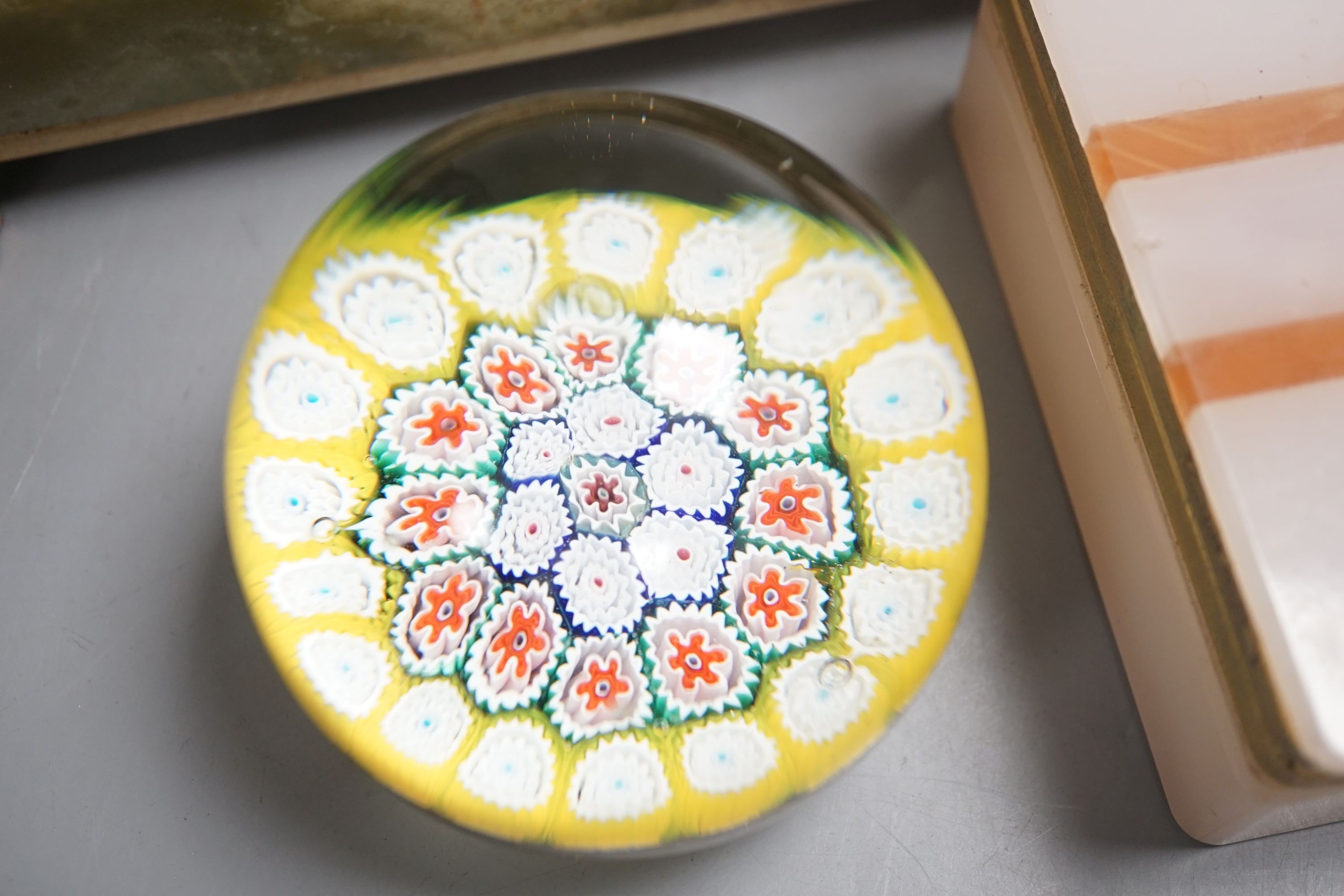 Three glass paperweights and two onyx boxes, largest 18cm